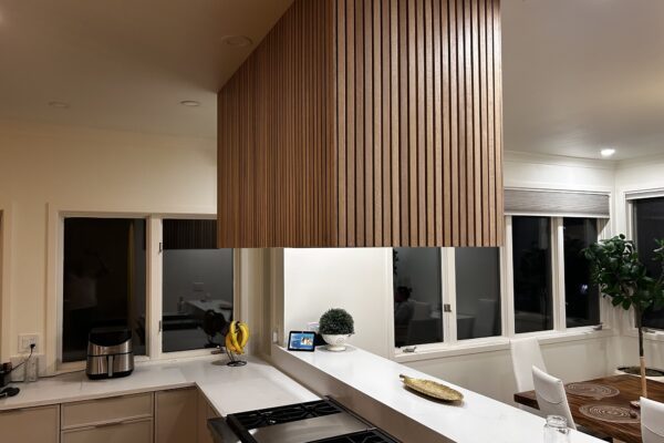 Custom Kitchen Remodel – Wood-Slat Cabinetry Custom remodeled kitchen with wood-slat cabinetry and quartz countertops