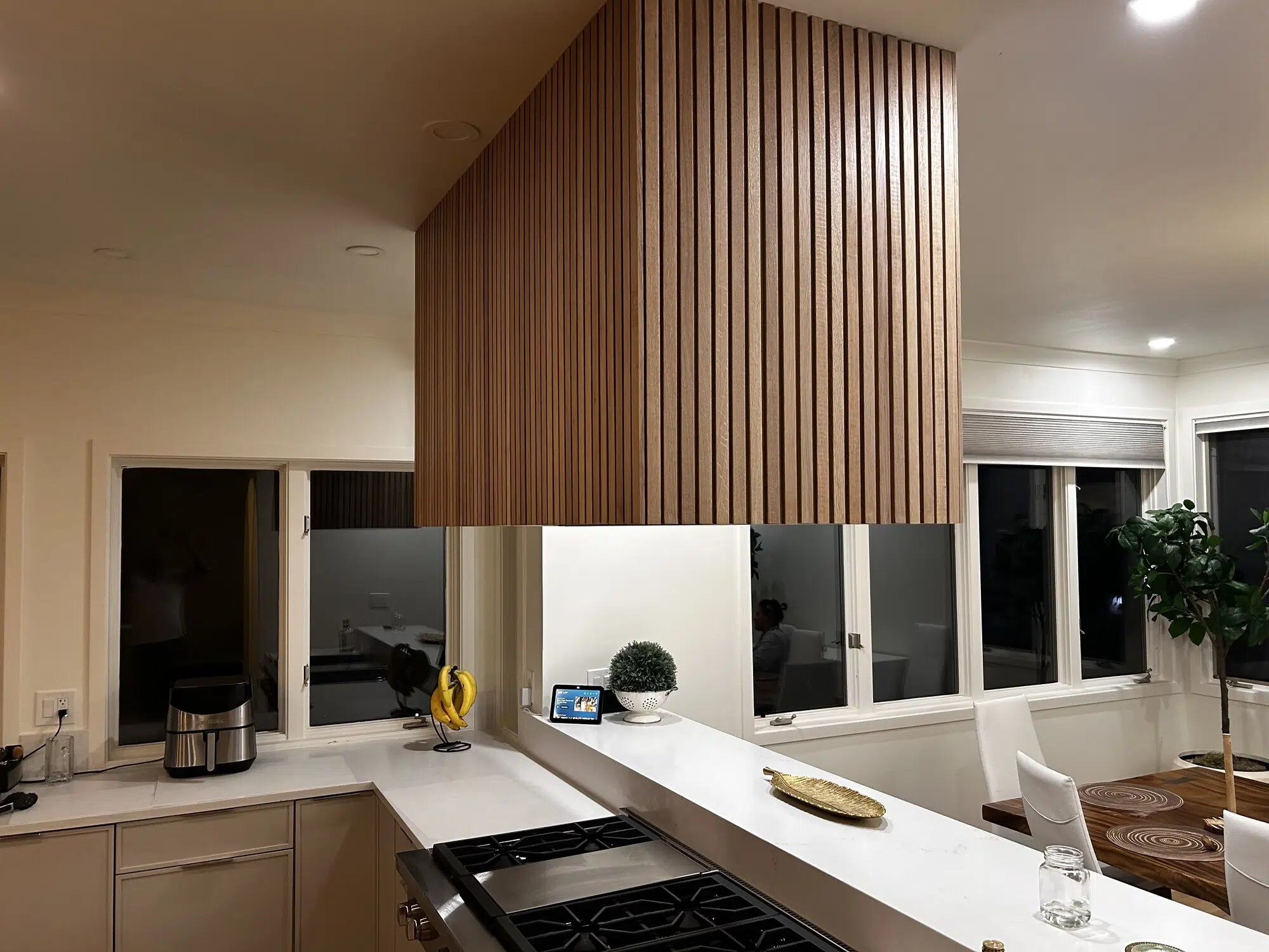 Custom remodeled kitchen with wood-slat cabinetry and quartz countertops