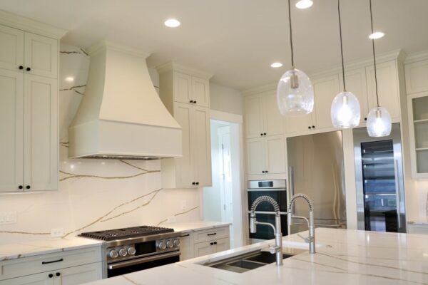 Custom White Kitchen Cabinets Custom white kitchen cabinets, quartz backsplash, and island