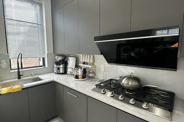 Modern Gray Kitchen Cabinets Modern gray kitchen cabinets with gas cooktop and marble backsplash