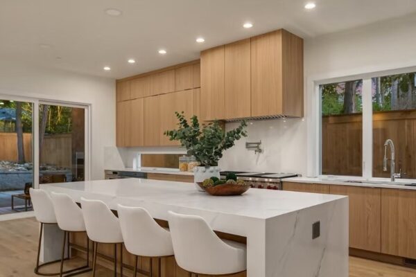 Modern Kitchen Remodel – Wood Cabinetry Modern remodeled kitchen with wood cabinets and waterfall island